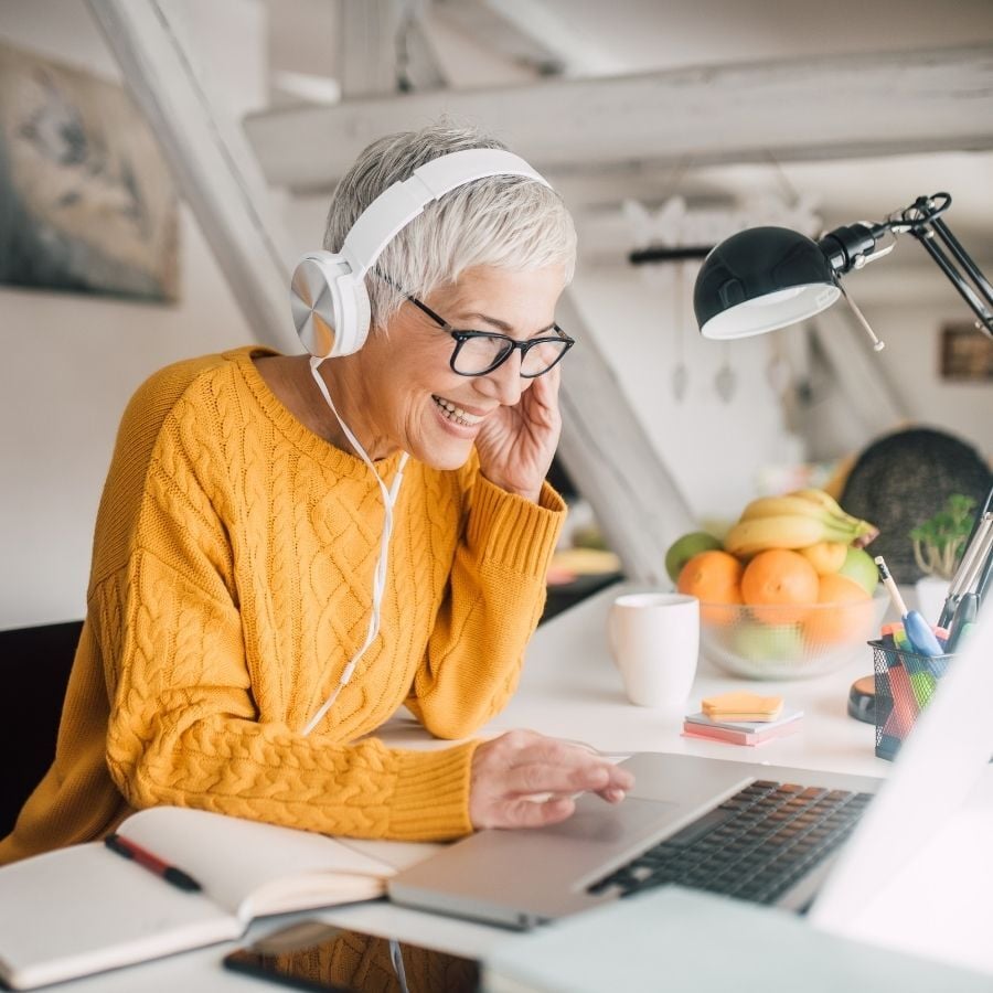 Older woman working from home smiling
